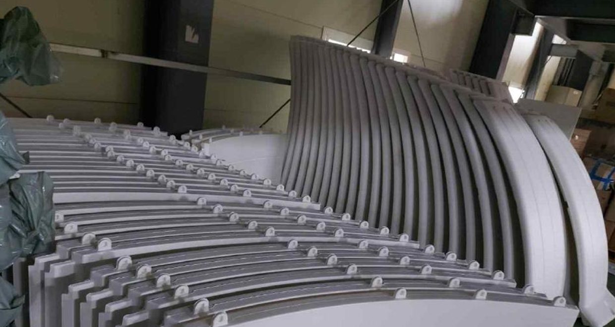 Wisdome House factory — HDPE dome panels stacked for export
